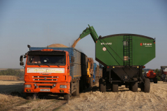 A Kamaz PJSC truck. Acros combine harvesters, manufactured by Rostselmash OJSC, during the summer wheat harvest on a farm operated by 'Svetlyi" Group of Companies, in Kamenka village, outside Rostov, Russia, July 5, 2019. http://gk-svetlyi.ru/